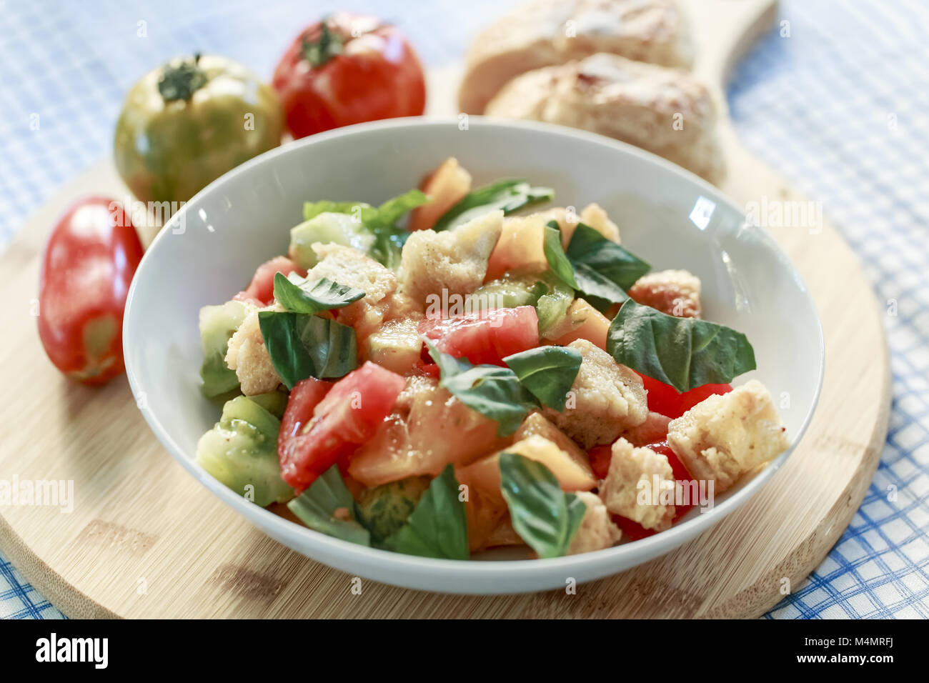 Colorful tomato bread salad with basil in white bowl Stock Photo