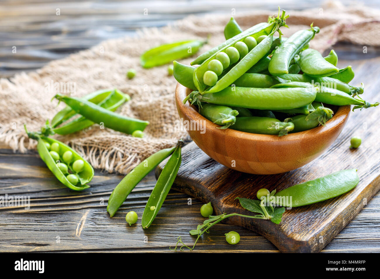 Wooden bowl with sweet pea pods. Stock Photo