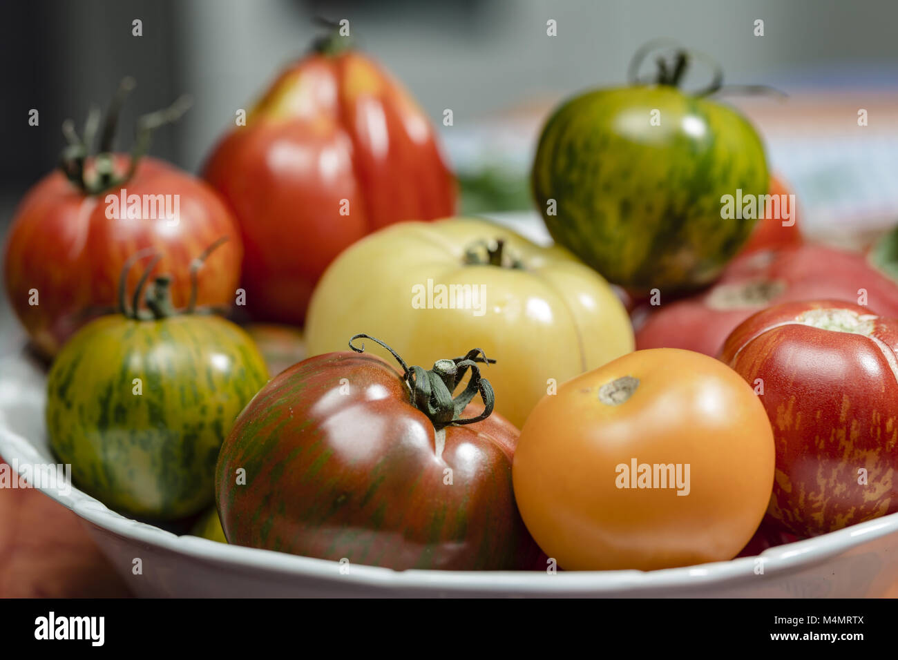 Heirloom Tomatoes in a white bowl Stock Photo Alamy