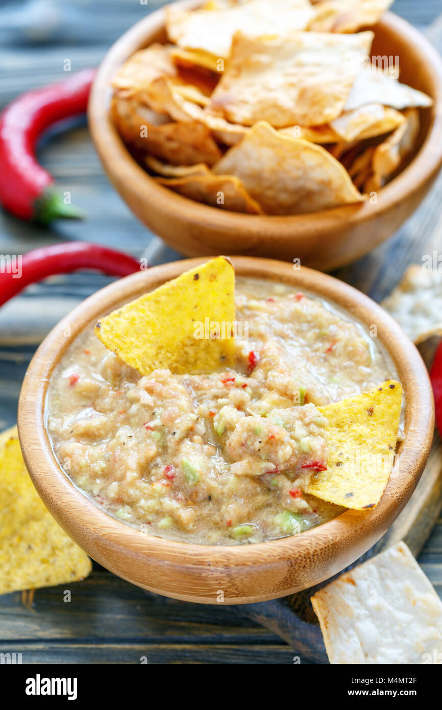 Spicy avocado dip with corn chips. Stock Photo