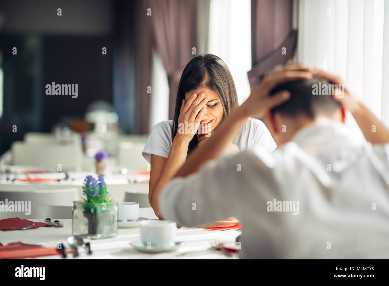 Crying stressed woman arguing with a man about problems.Reaction to negative event,handling bad news.Breaking up long relationship.Emotional troubled  Stock Photo