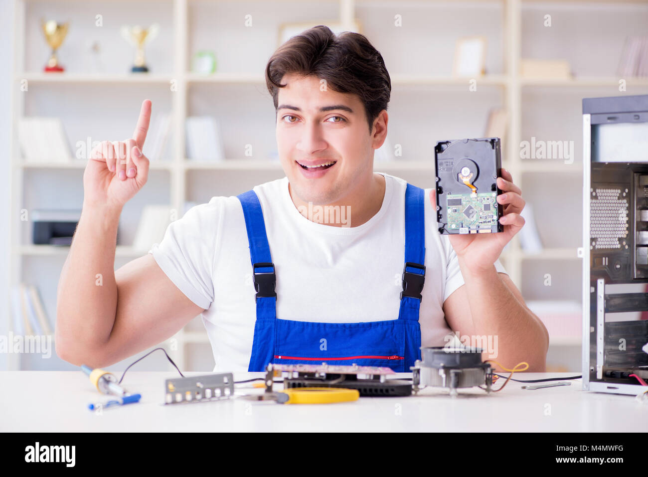Computer Rebort Man Computer repairman repairing desktop computer Stock Photo - Alamy