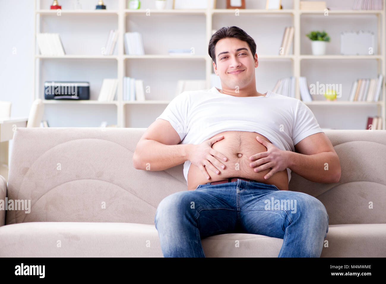 Man suffering from extra weight in diet concept Stock Photo