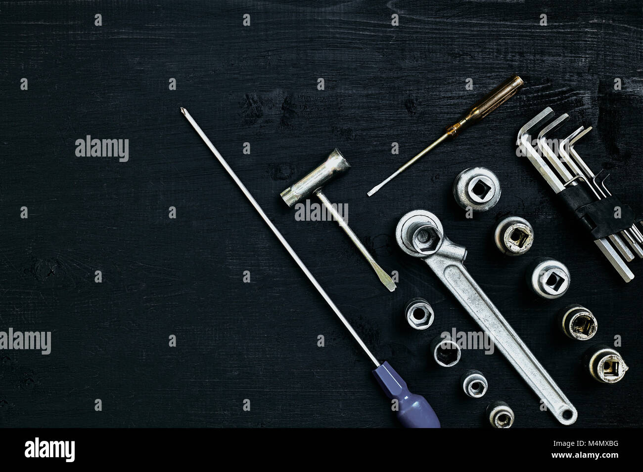 Set of hand bunch of tools in the garage on black wooden background. Close up. Top view. Space for your text or product display. Still life. Flat lay Stock Photo