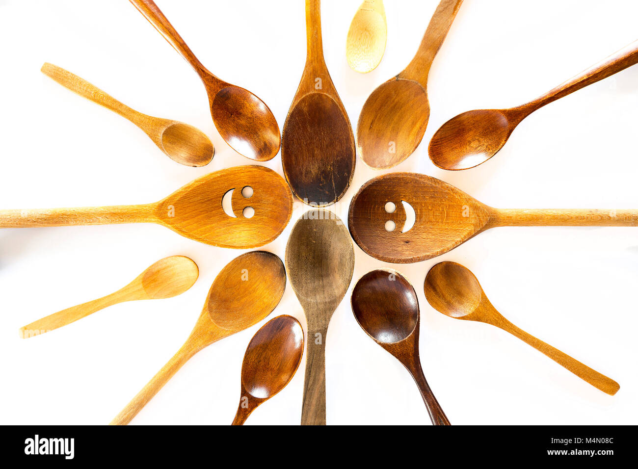 Wooden smiley face spoons on a white background. Studio shot. Set of