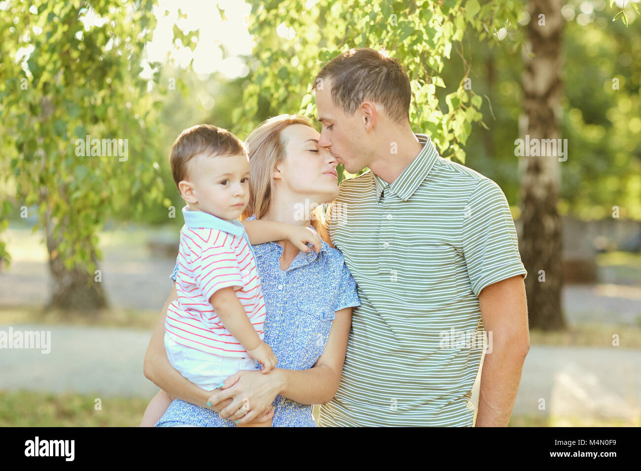 Portrait of a happy family in the park Stock Photo - Alamy