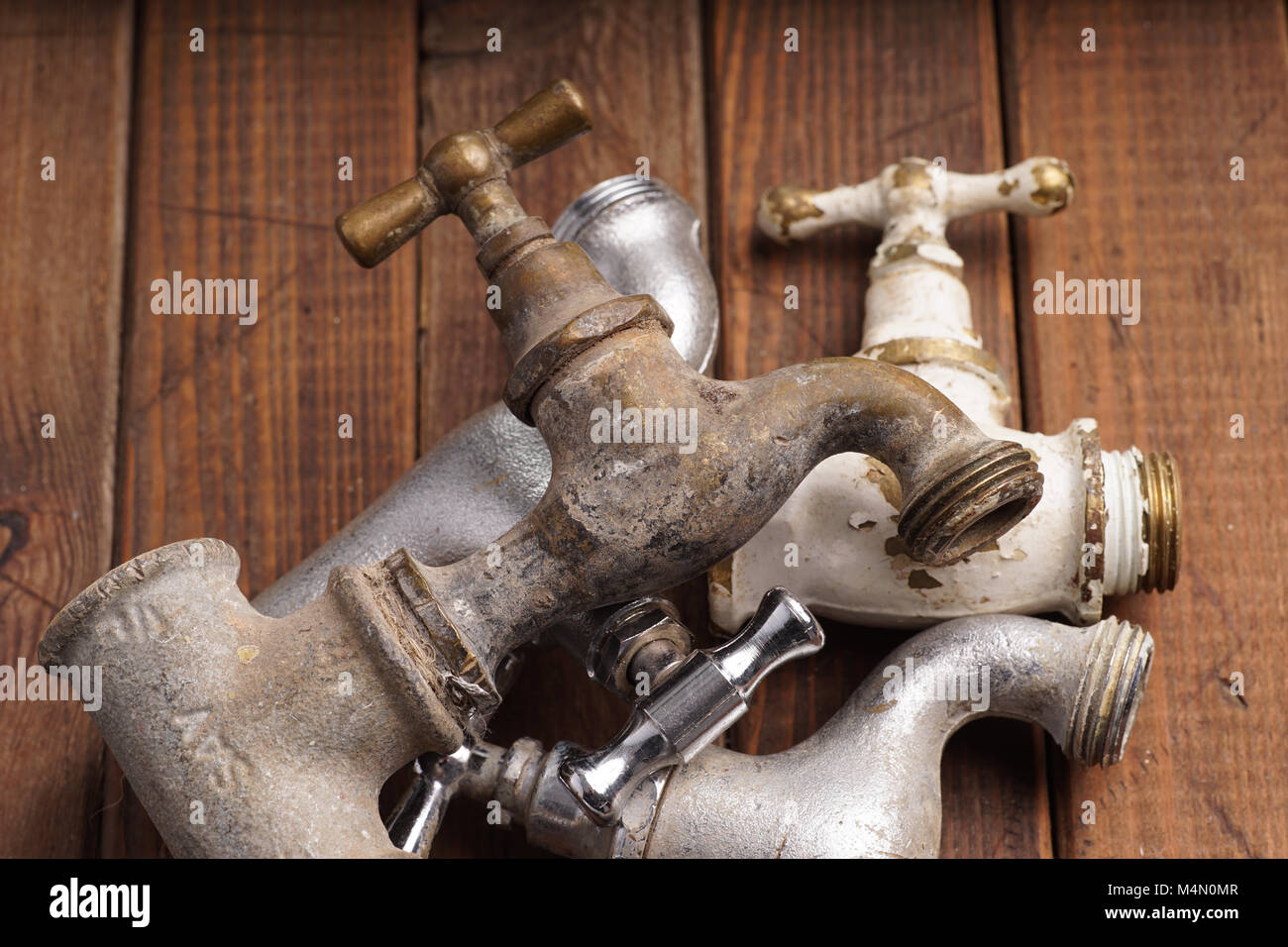 Plumber Tool Faucet For House Repair Lying On Wooden Background