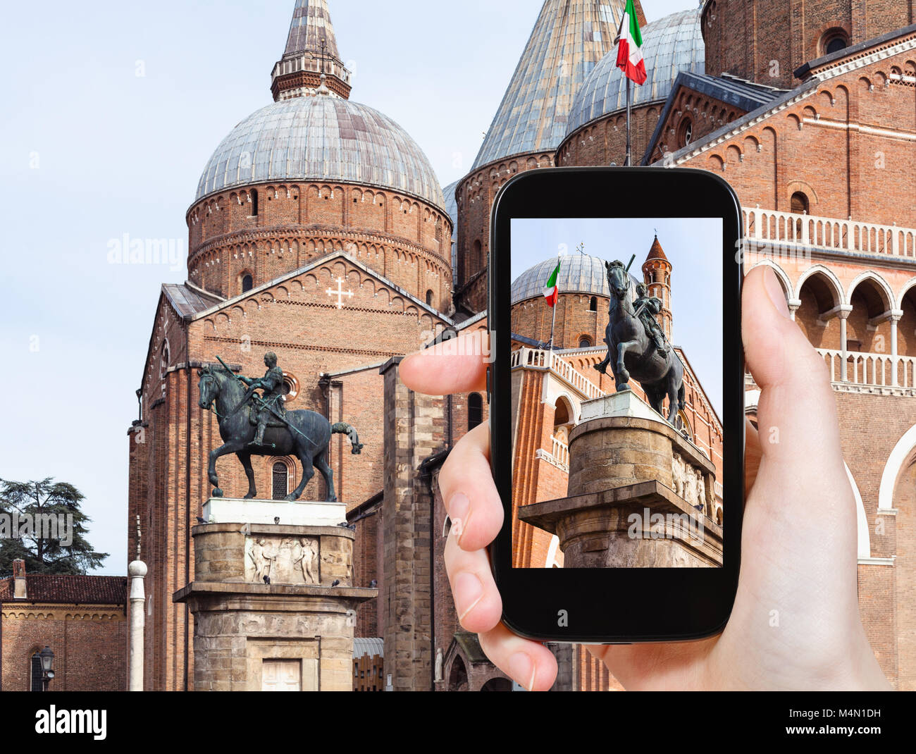 travel concept - tourist photographs The Equestrian Statue of Gattamelata by Donatello and Basilica of Saint Anthony of Padua on square piazza del San Stock Photo