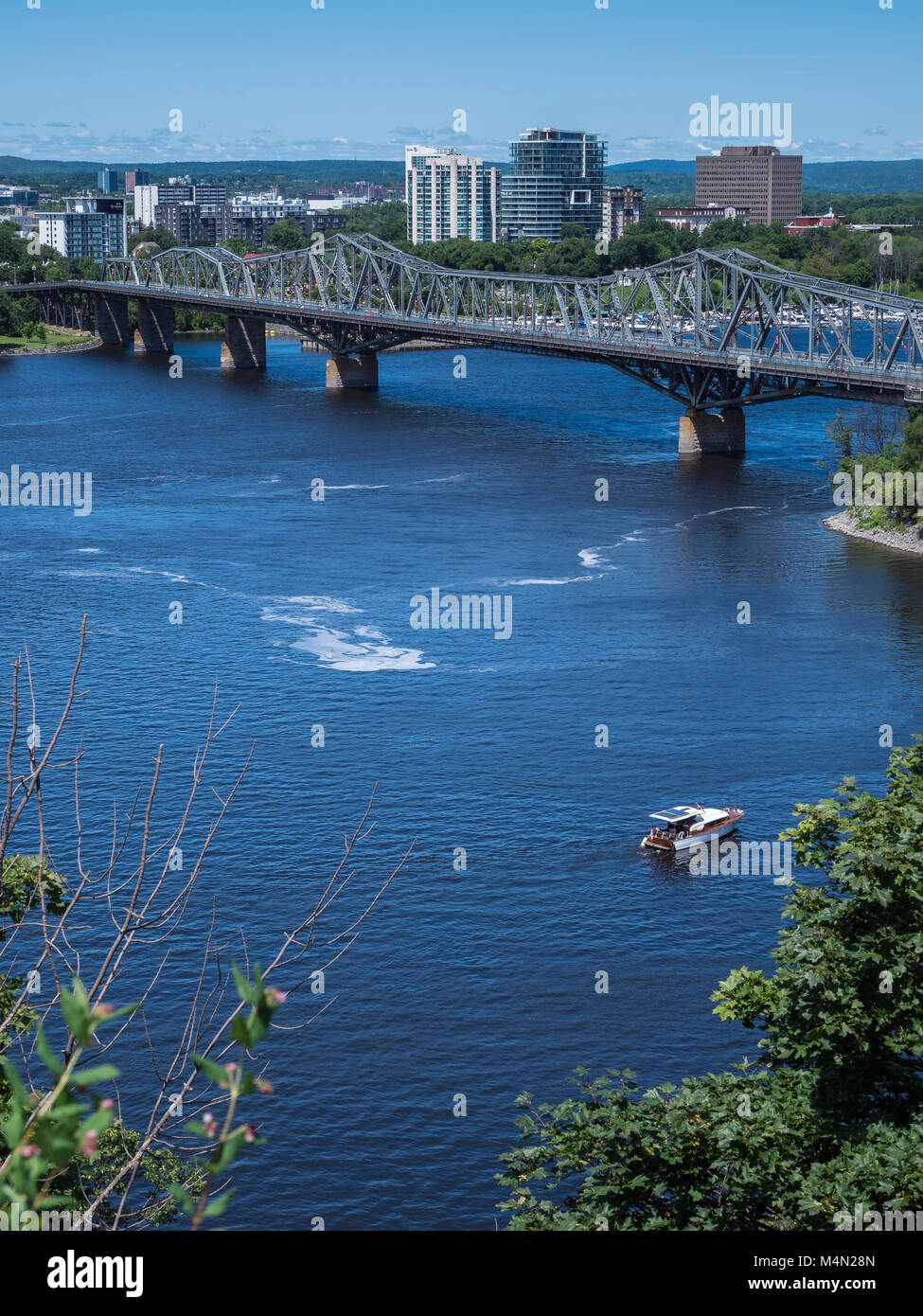 Boats on the Ottawa River near the Alexandra Bridge, Ottawa, Ontario, Canada. Stock Photo