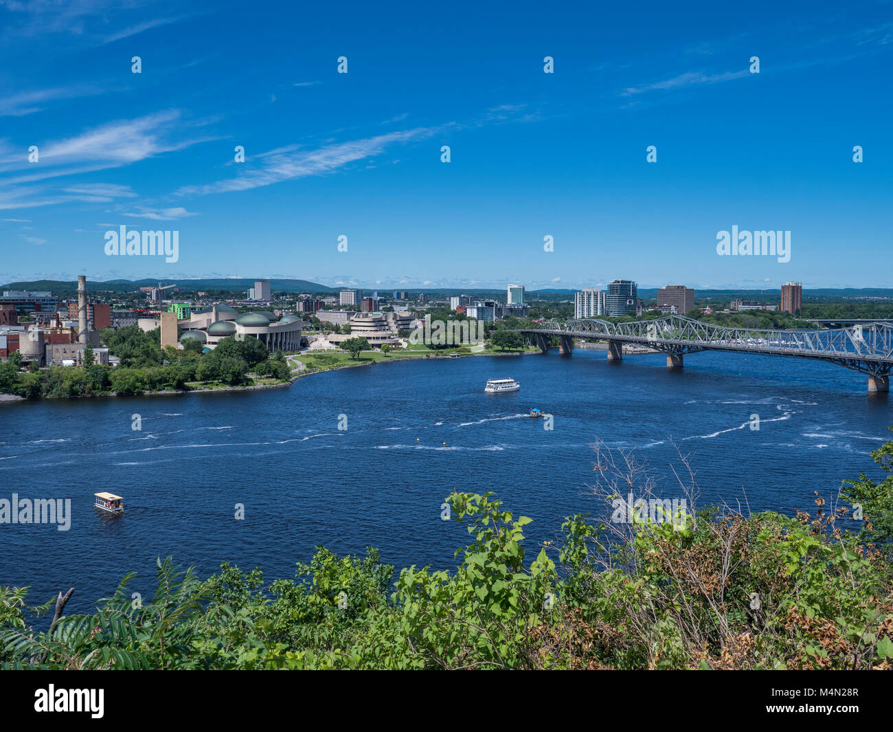 Boats on the Ottawa River near the Alexandra Bridge, Ottawa, Ontario, Canada. Stock Photo