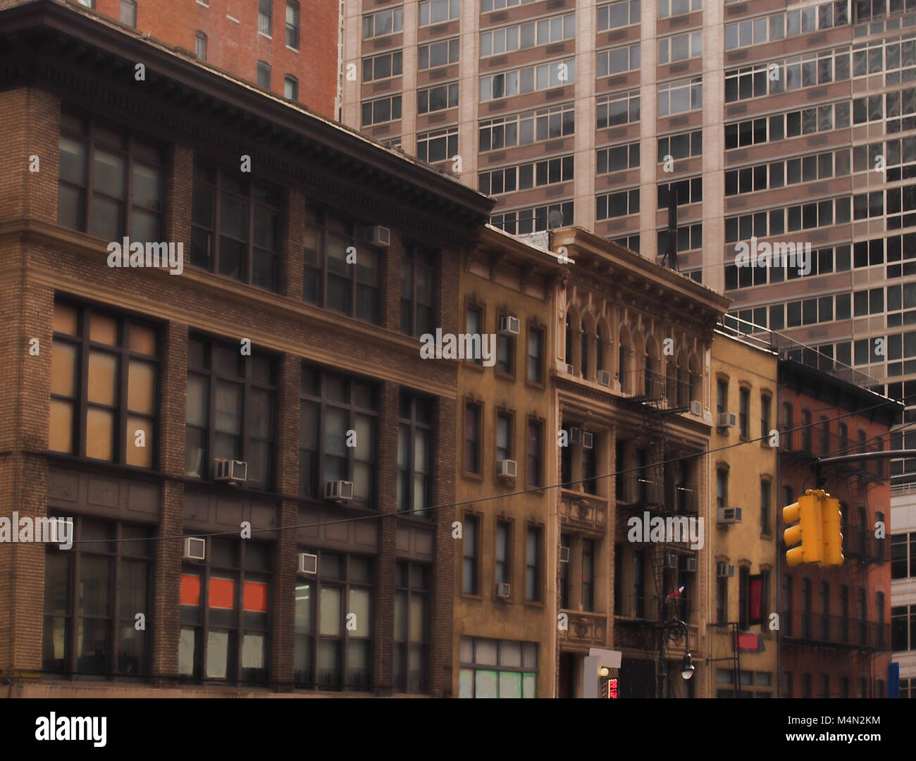 Vintage old building surrounded by modern office buildings in New York ...