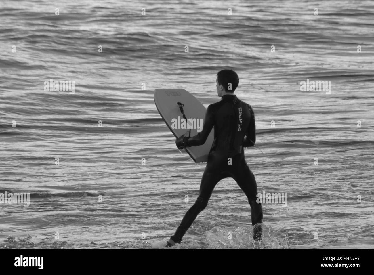 Male Bodyboarder Surfing the North Sea Waves at Aberdeen Beach, Scotland, UK. Winter 2018. Stock Photo