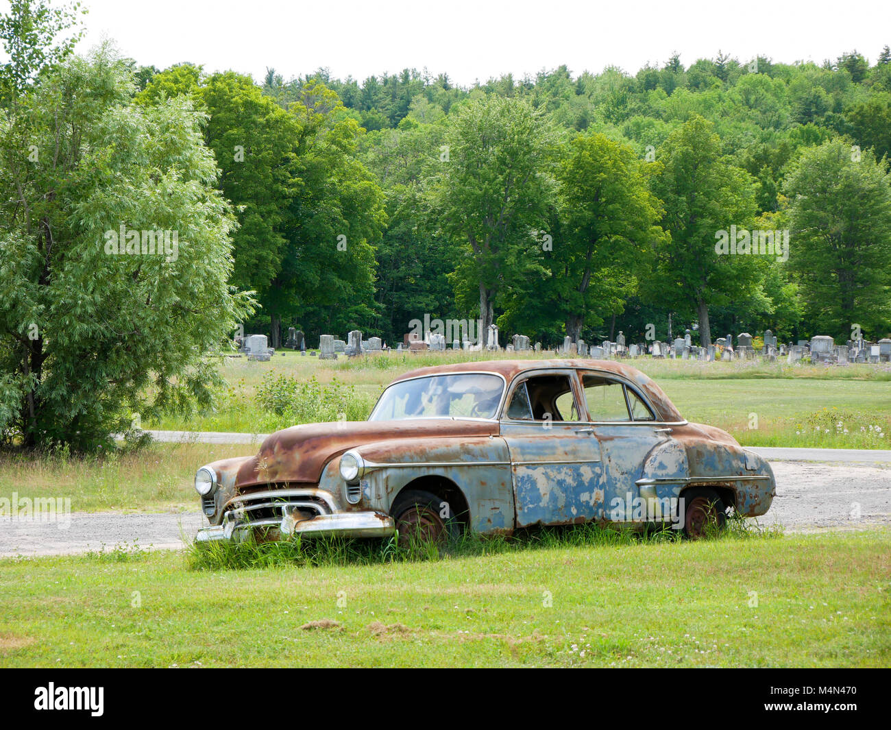 An Old Abandoned Car In Front Of A Cemetery Stock Photo Alamy