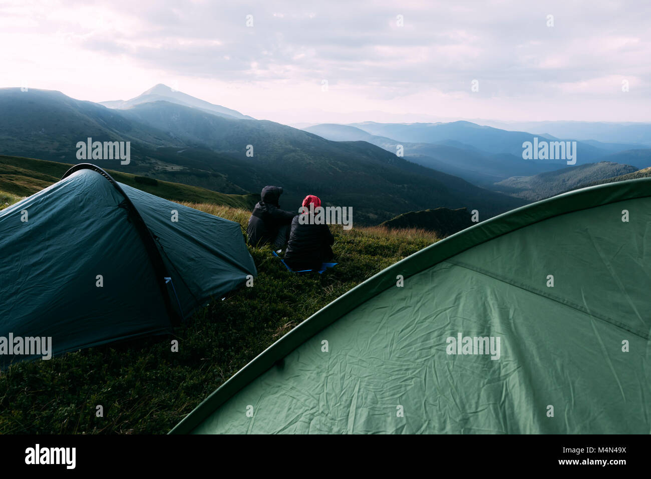 Couple near tent on mountains closeup Stock Photo