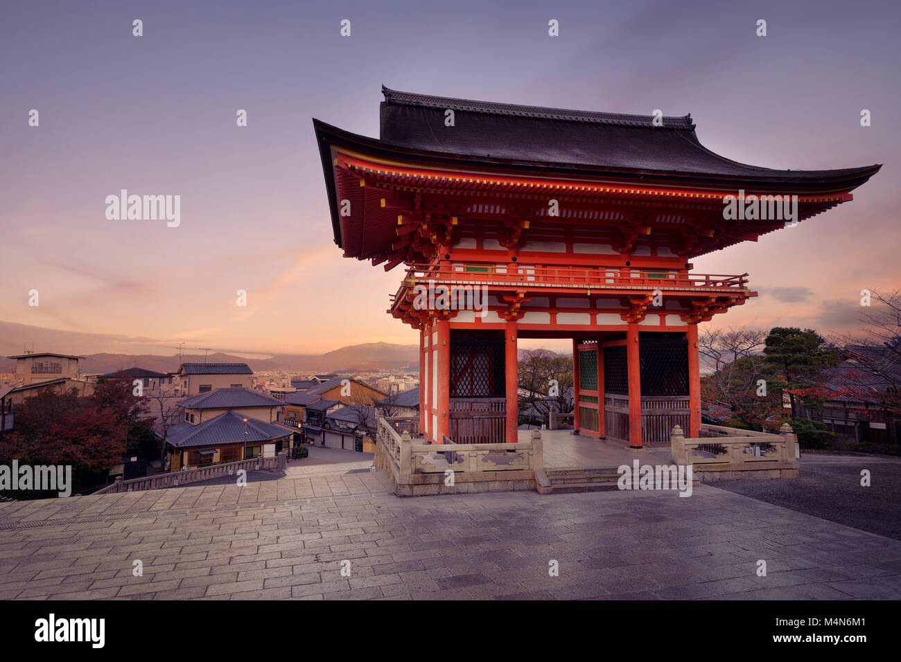 Nio-mon gate of Kiyomizu-dera Buddhist temple in a sunrise morning scenery. Two-storied Romon gate with Kyoto city landscape in the background. Higash Stock Photo