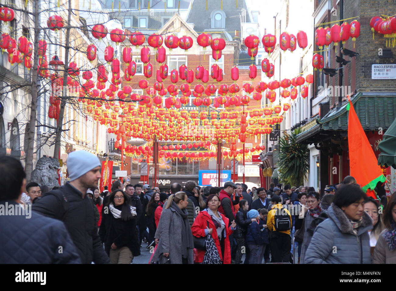 London, UK. 17th Feb, 2018. Londoners seen walking below Chinese lanterns in China Town London on 17 February 2018 ahead of the Year of the Dog celebration in London. The main London festivities kick off with a vibrant parade in and around Chinatown, followed by spectacular free stage performances in Trafalgar Square on 18 February.  Credit: David Mbiyu/Alamy Live News Stock Photo