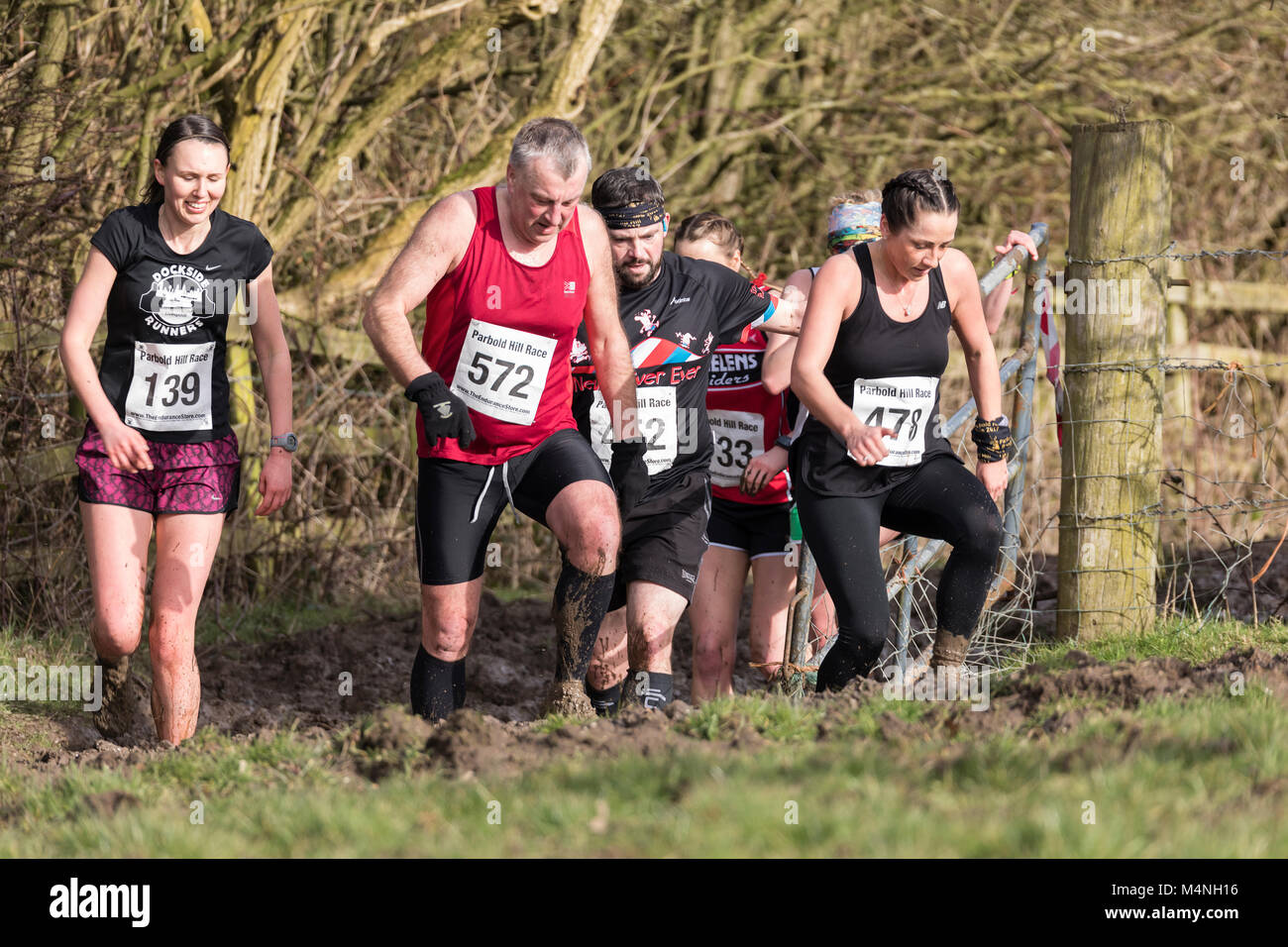 Lancashire, UK. 17th Feb, 2018. Skelmersdale Boundary Harriers organized the the 48th PARBOLD HILL RACE today, Saturday 17 Feb 2018 The race started at 2:00pm. over 6.75 miles multi terrain. The start/finish was at Richard Durning's Endowed Primary School,. Chorley Rd, Bispham, Nr. Parbold. Conditions were very muddy in West Lancashire this afternoon, although the race took place in nice sunshine. Credit: Dave McAleavy Images/Alamy Live News Stock Photo