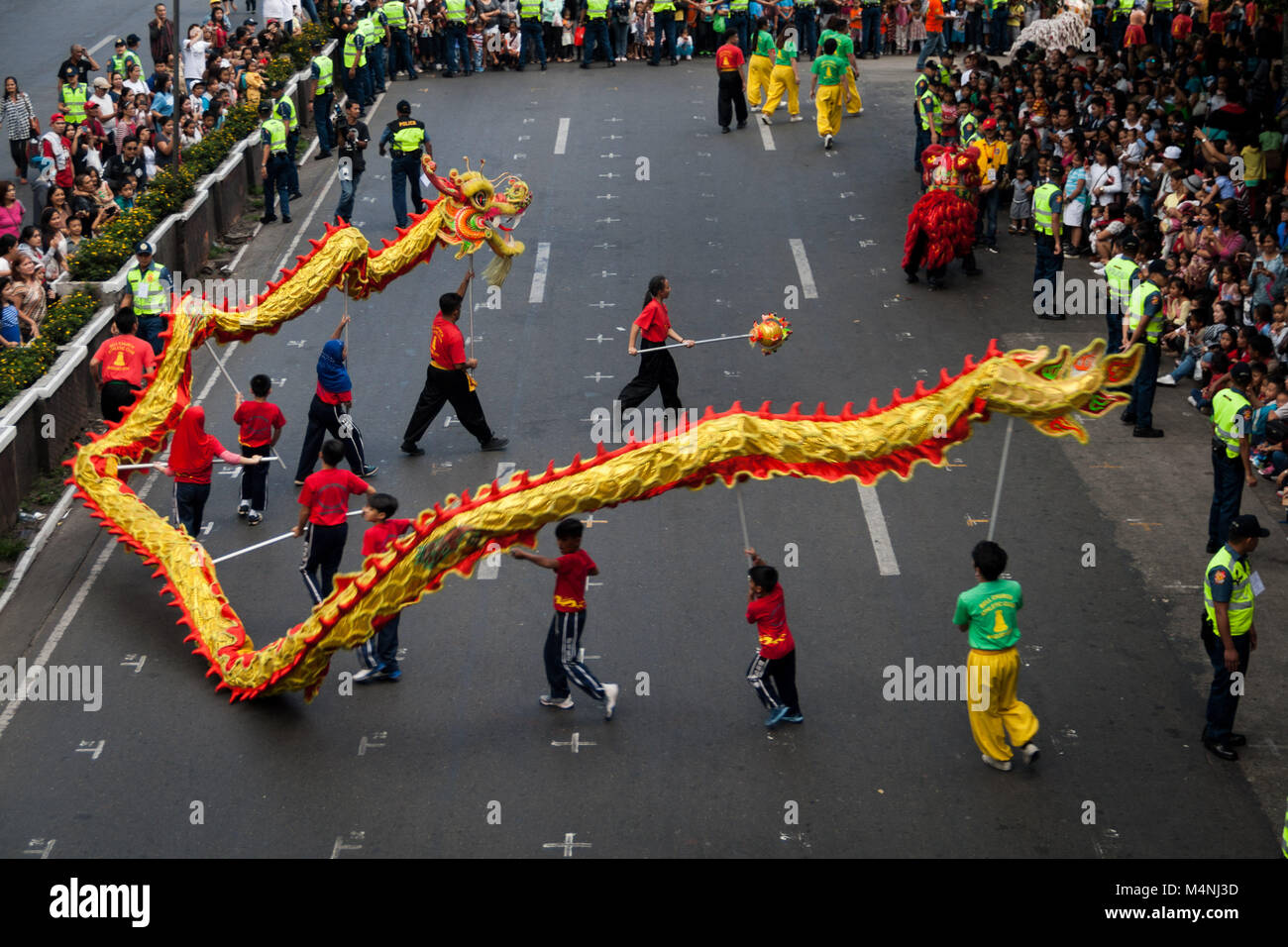 Baguio City, Philippines. 17th Feb, 2018. Lion and dragon dancers perform as crowds gather along Session Road in the city if pines, Baguio. Thousands participated on the Chinese New Year parade held along Session Road in Baguio City, Benguet, north of Manila. The Baguio Filipino-Chinese community lead the parade through the city streets during the month long Panagbenga Festival. Credit: J Gerard Seguia/ZUMA Wire/Alamy Live News Stock Photo