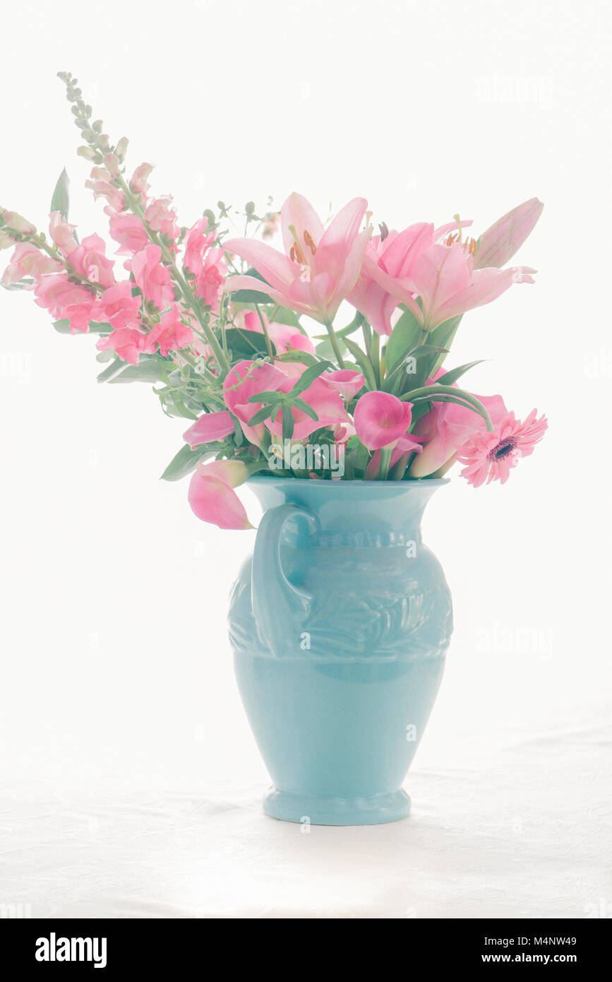 Pink bouquet in a blue vase with white background Stock pink bouquet in a blue vase with white background M4NW49