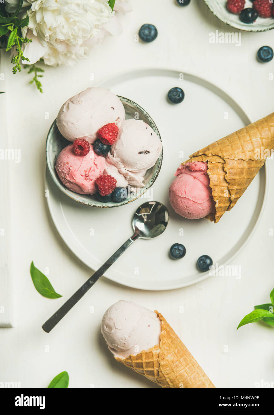 Flatlay of Pink strawberry and coconut ice cream scoops in bowl, sweet