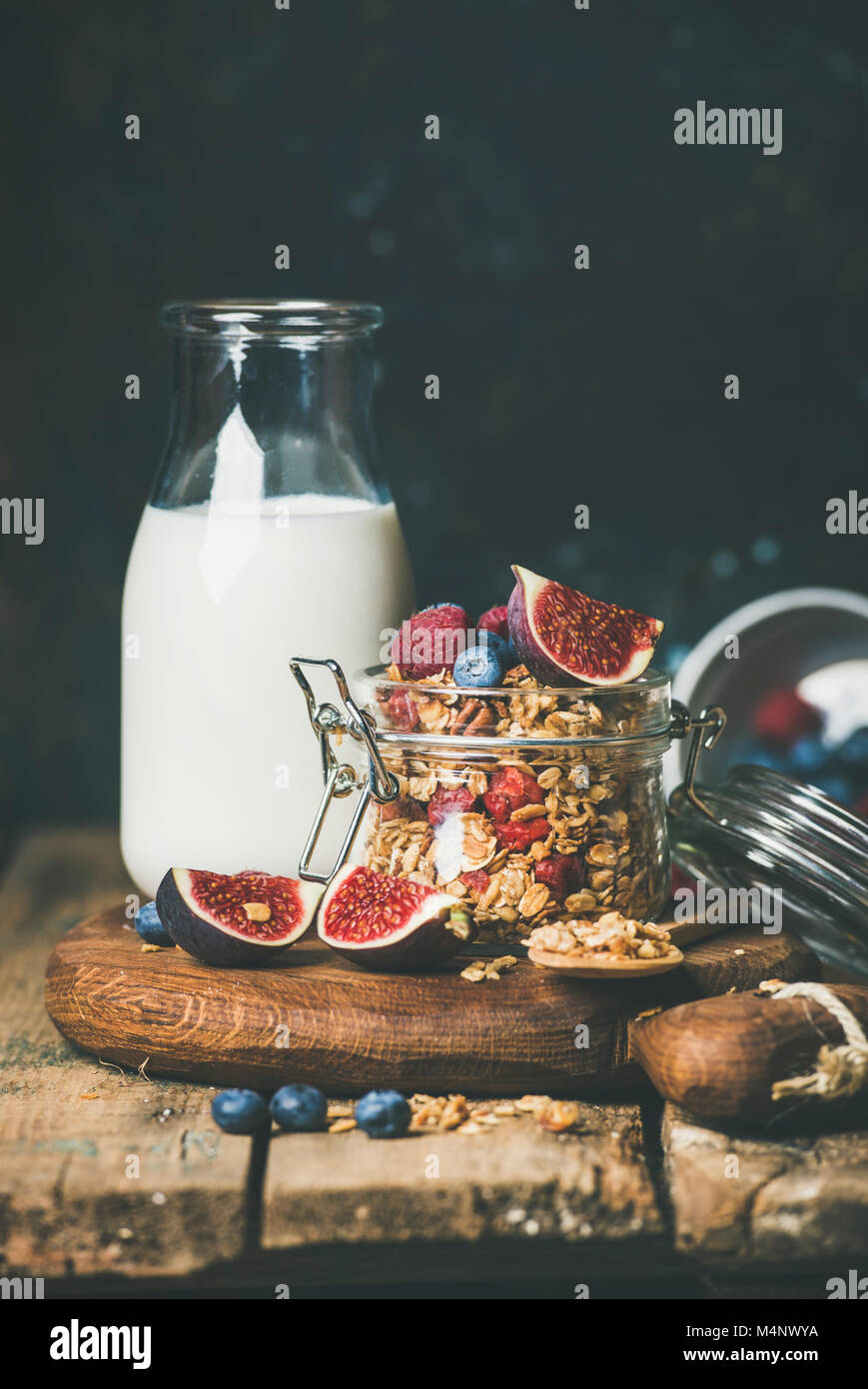 Healthy vegan breakfast. Oatmeal granola with bottled almond milk, honey, fruit and berries over