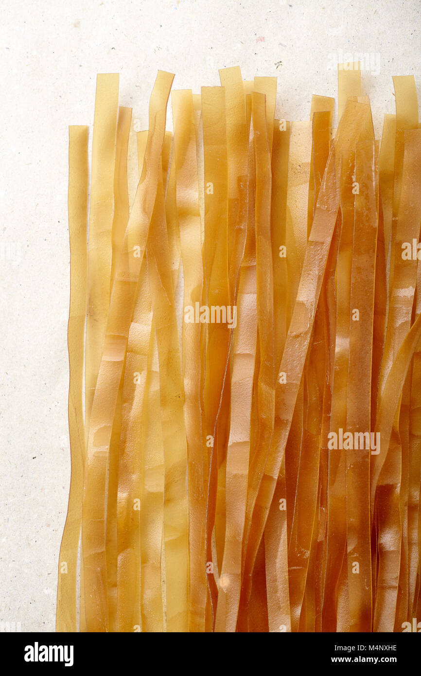 Close up shot of flat and thick rice noodles made with coconut milk. Traditional chinese cuisine