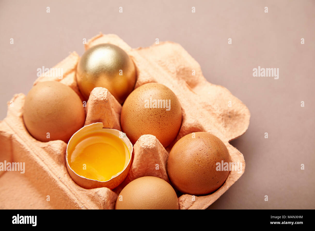 Half Dozen of chicken eggs in colorful cardboard container with one