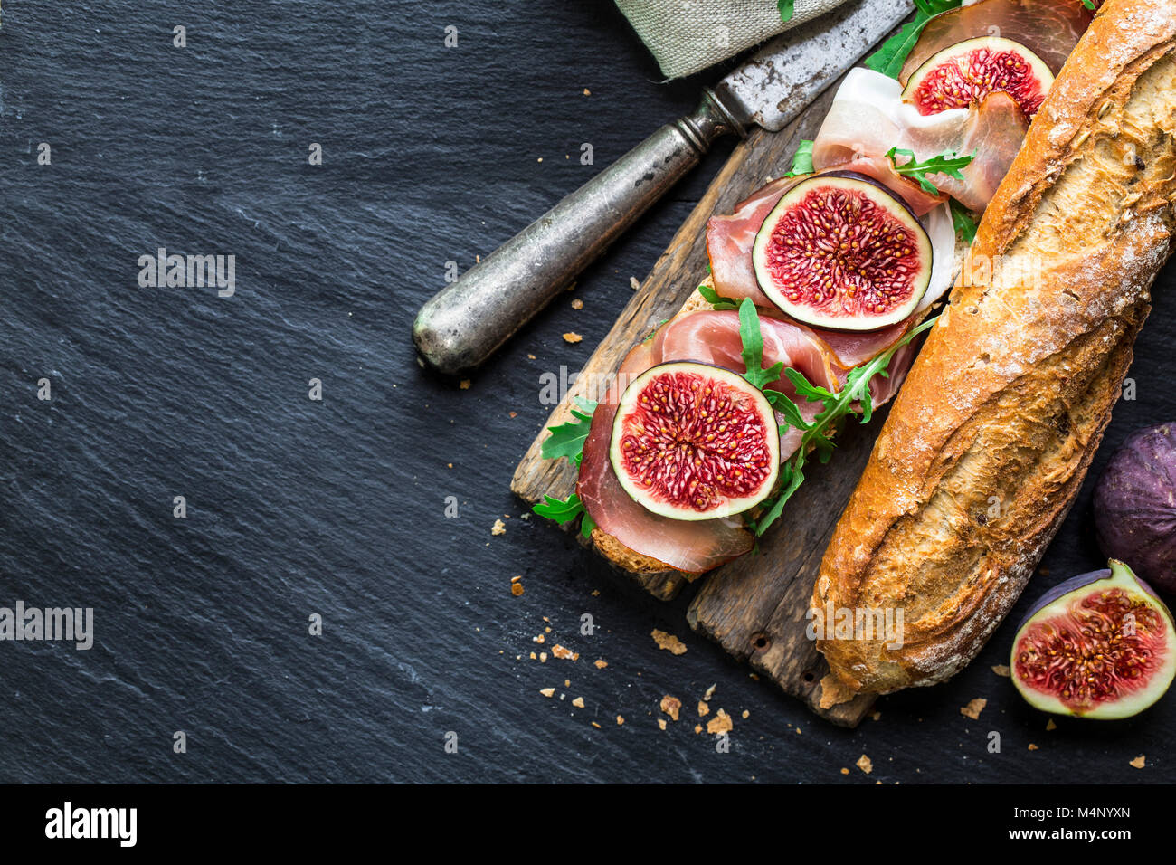 Baguette sandwich with figs, prosciutto and arugula Stock Photo Alamy