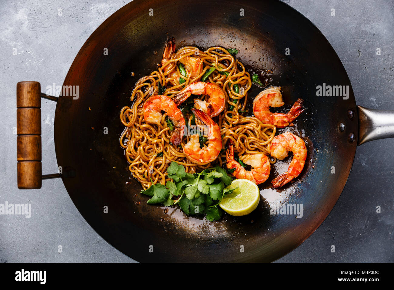 Ramen stir-fry noodles with shrimp in wok pan on gray concrete background  close-up Stock Photo - Alamy