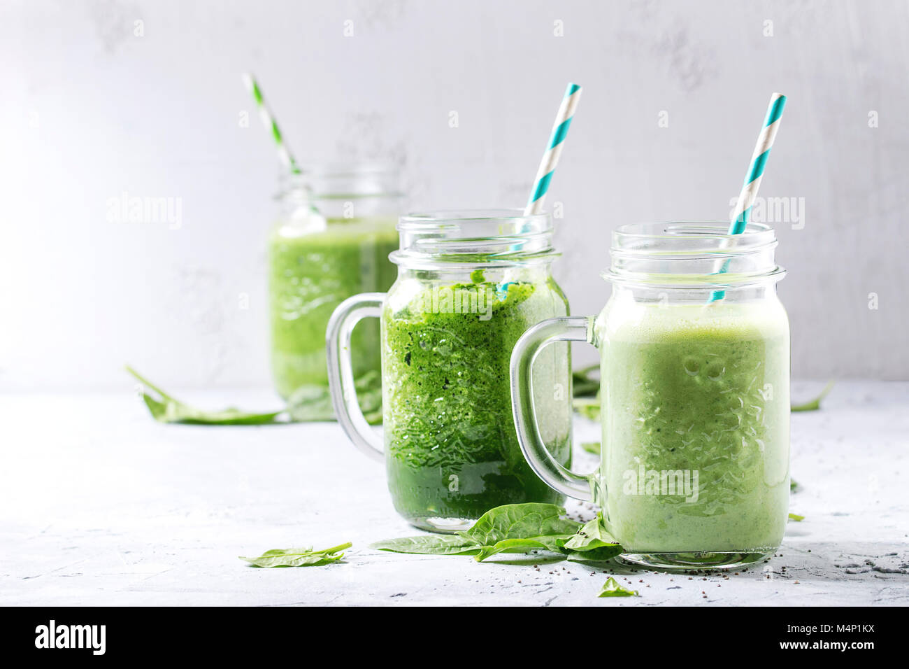 Variety of three color green spinach kale apple yogurt smoothie in