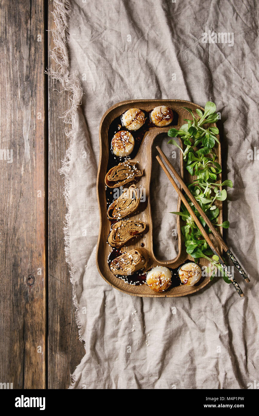 Asian style fried scallops with Japanese Rolled Omelette Tamagoyaki and soy sesame sauce in