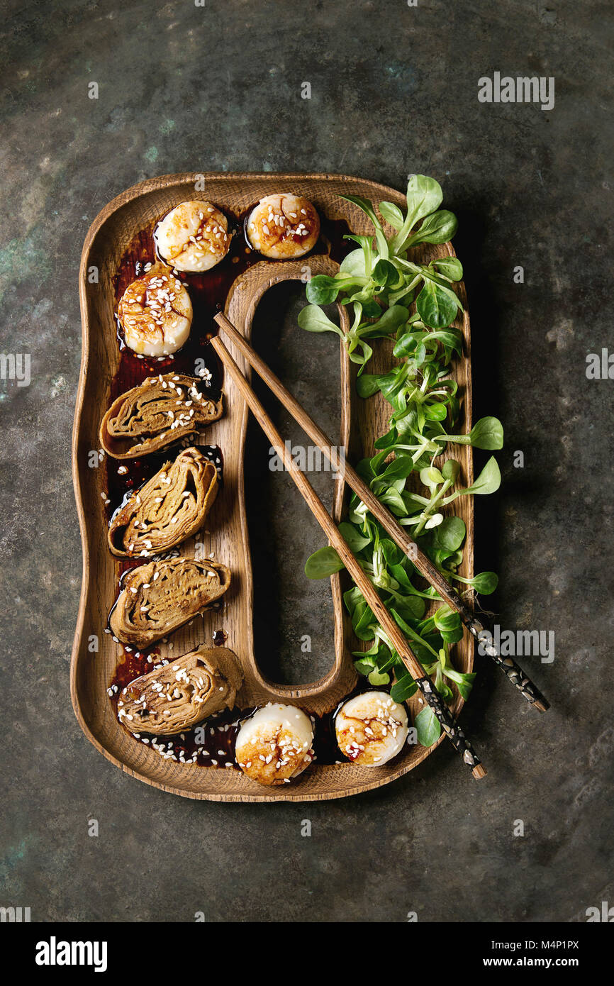 Asian style fried scallops with Japanese Rolled Omelette Tamagoyaki and soy sesame sauce in