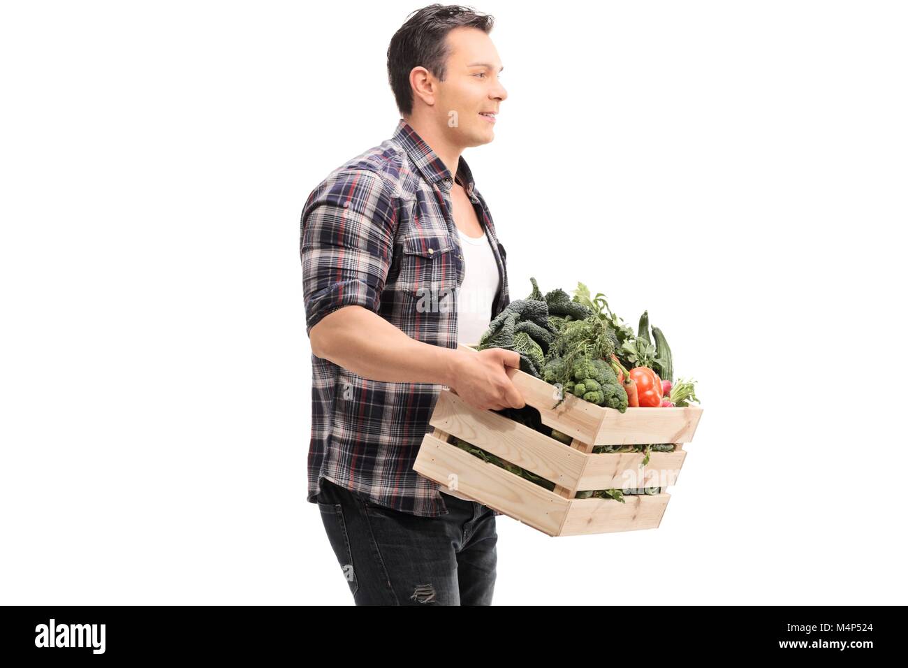 Farmer holding a crate full of vegetables isolated on white background ...