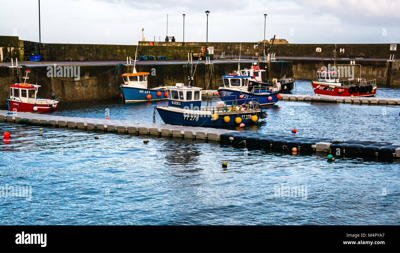 Small fishing boats in harbour, picturesque seaside village of Gardenstown, Aberdeenshire, Scotland, UK Stock Photo