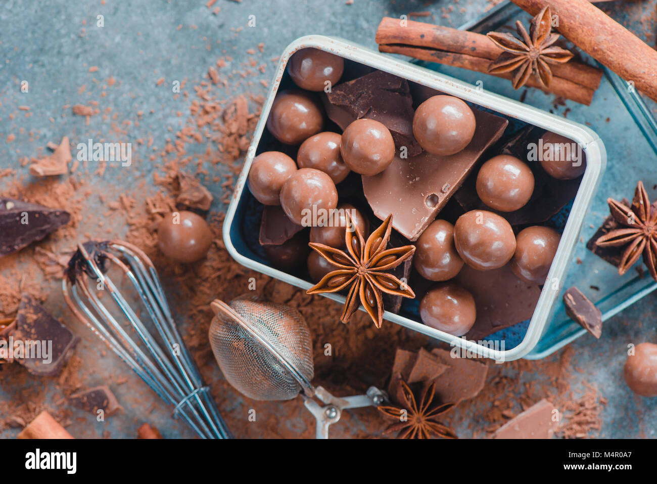 Round chocolates in a rustic metal box. Confectionery food photography. Close-up with copy space. Stock Photo