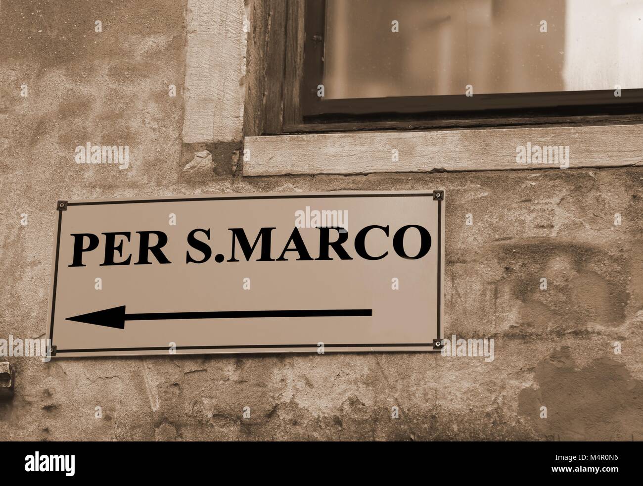 signpost with directions to go to St. Mark's Square in Venice in Italy with sepia toned Stock Photo