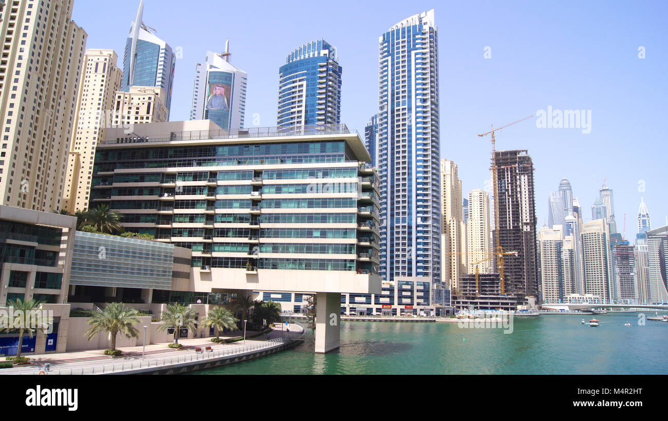 DUBAI, UNITED ARAB EMIRATES - APRIL 2nd, 2014: View on Dubai Marina skyscrapers and the most luxury superyacht marina Stock Photo