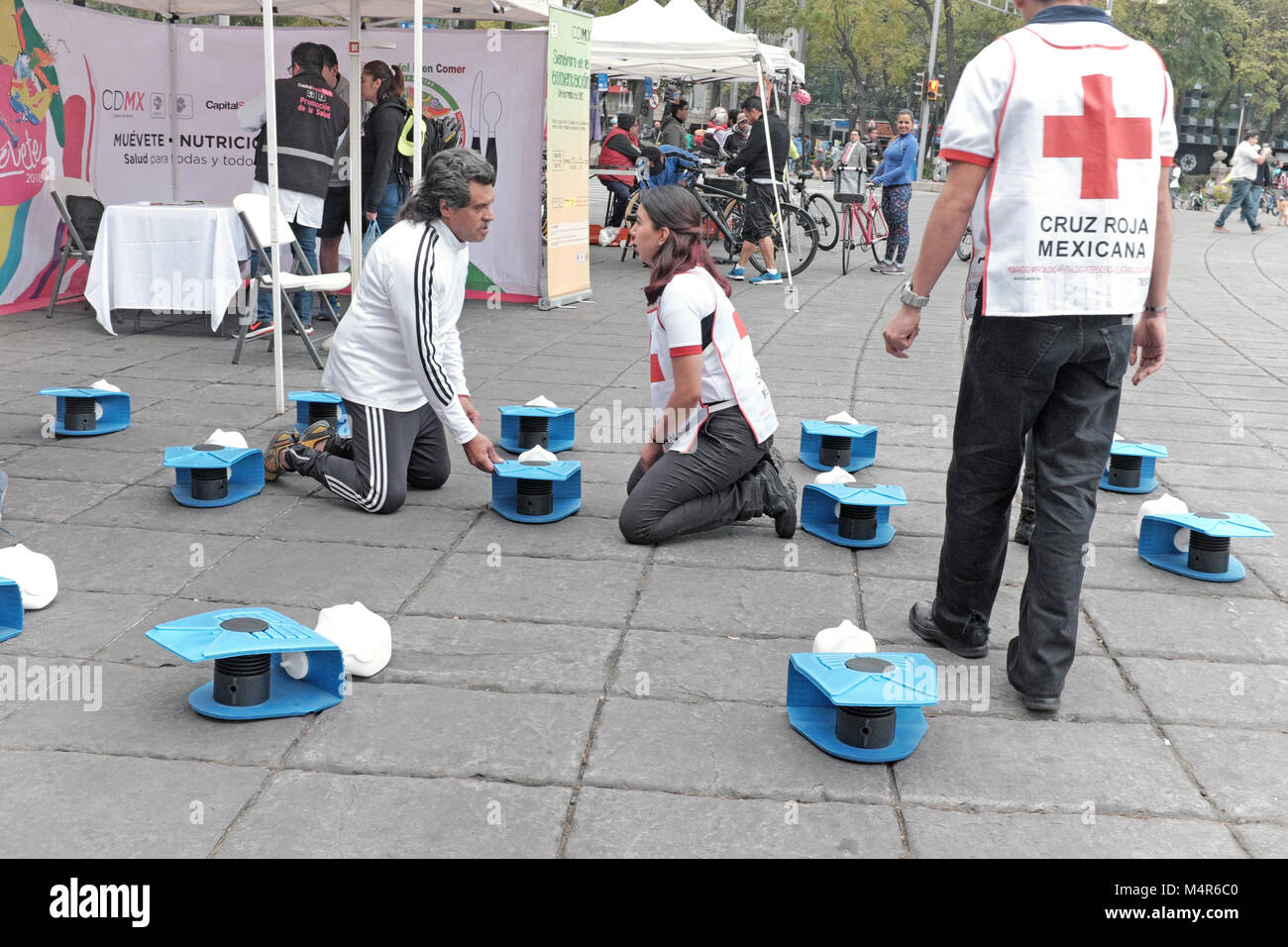 Cruz Roja Mexicana volunteers demonstrate CPR for people who are interested in learning the technique at a booth on Paseo de Reforma in Mexico City. Stock Photo