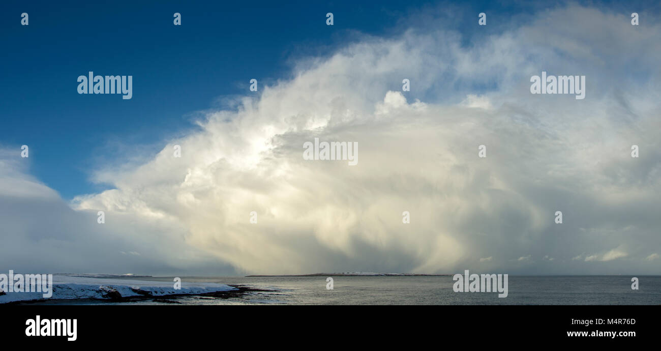 Huge cumulonimbus cloud over the Pentland Firth, from near the Ness of Duncansby, Caithness, Scotland, UK. The Isle of Stroma at centre. Stock Photo