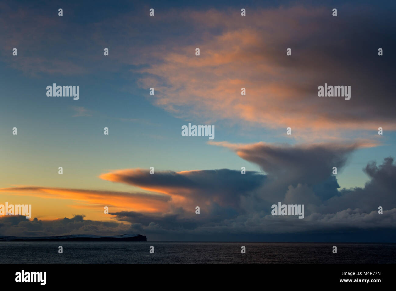 Cumulonimbus cloud at sunset over Dunnet Head and the Pentland Firth, from St. John's Point, Caithness, Scotland, UK Stock Photo