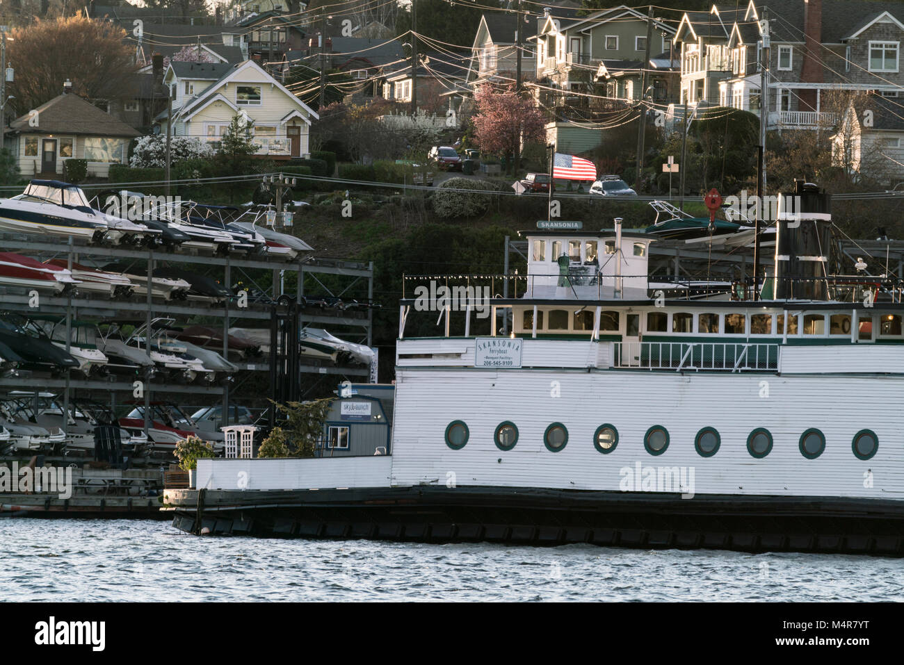 United States, Washington, Seattle, Decommissioned ferryboat tied up to the short of Lake Union with the Wallingford neighborhood behind. Stock Photo