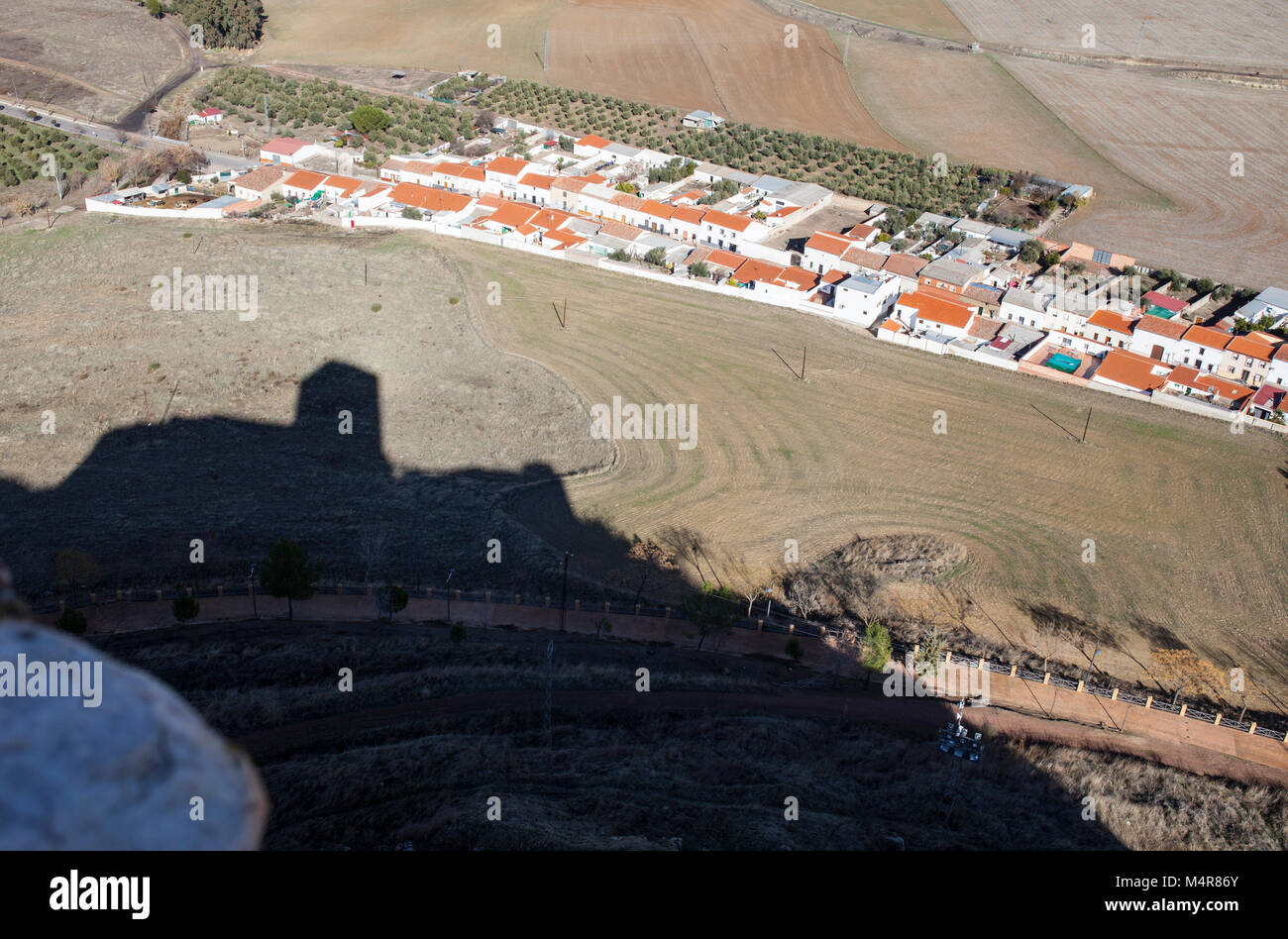 Castle of Belmez shadow getting close to town, Cordoba, Spain. Situated on the high rocky hill overlooking town of Belmez Stock Photo