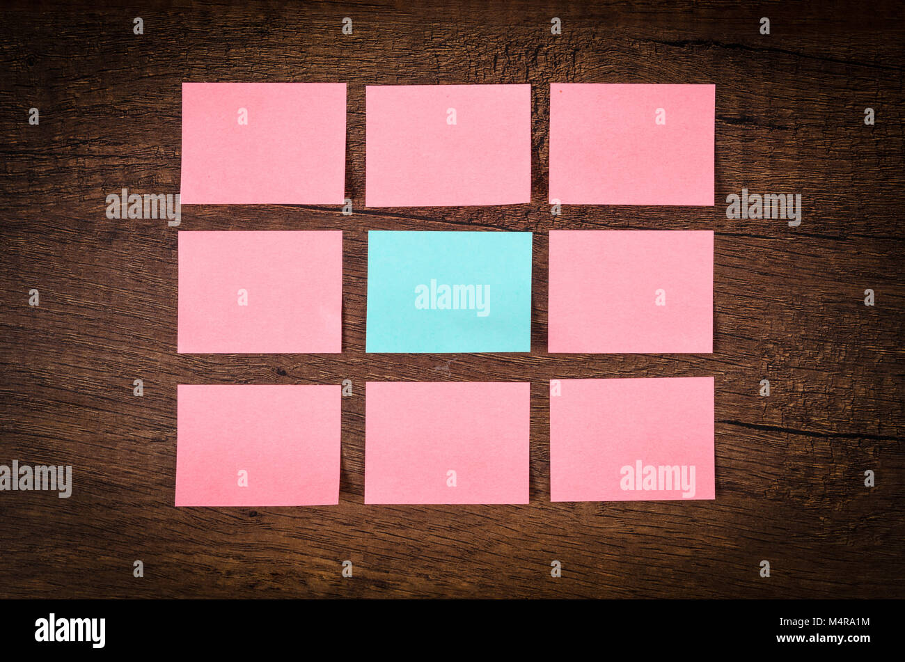 Blank many pink sticky notes for your text or message on wooden wall. Stock Photo