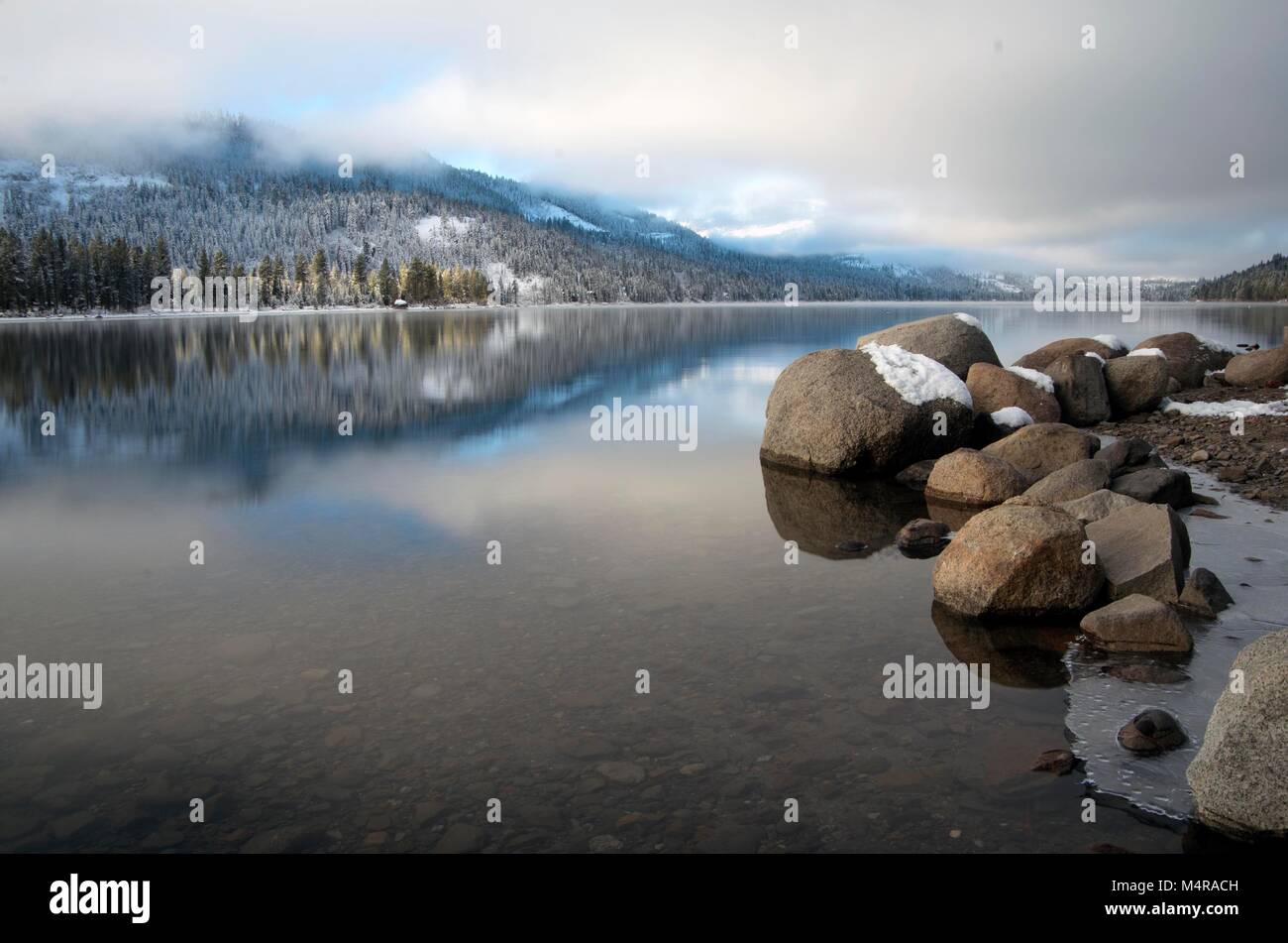 Patchy fog hovers over Donner Lake, CA, during an early January morning. Stock Photo