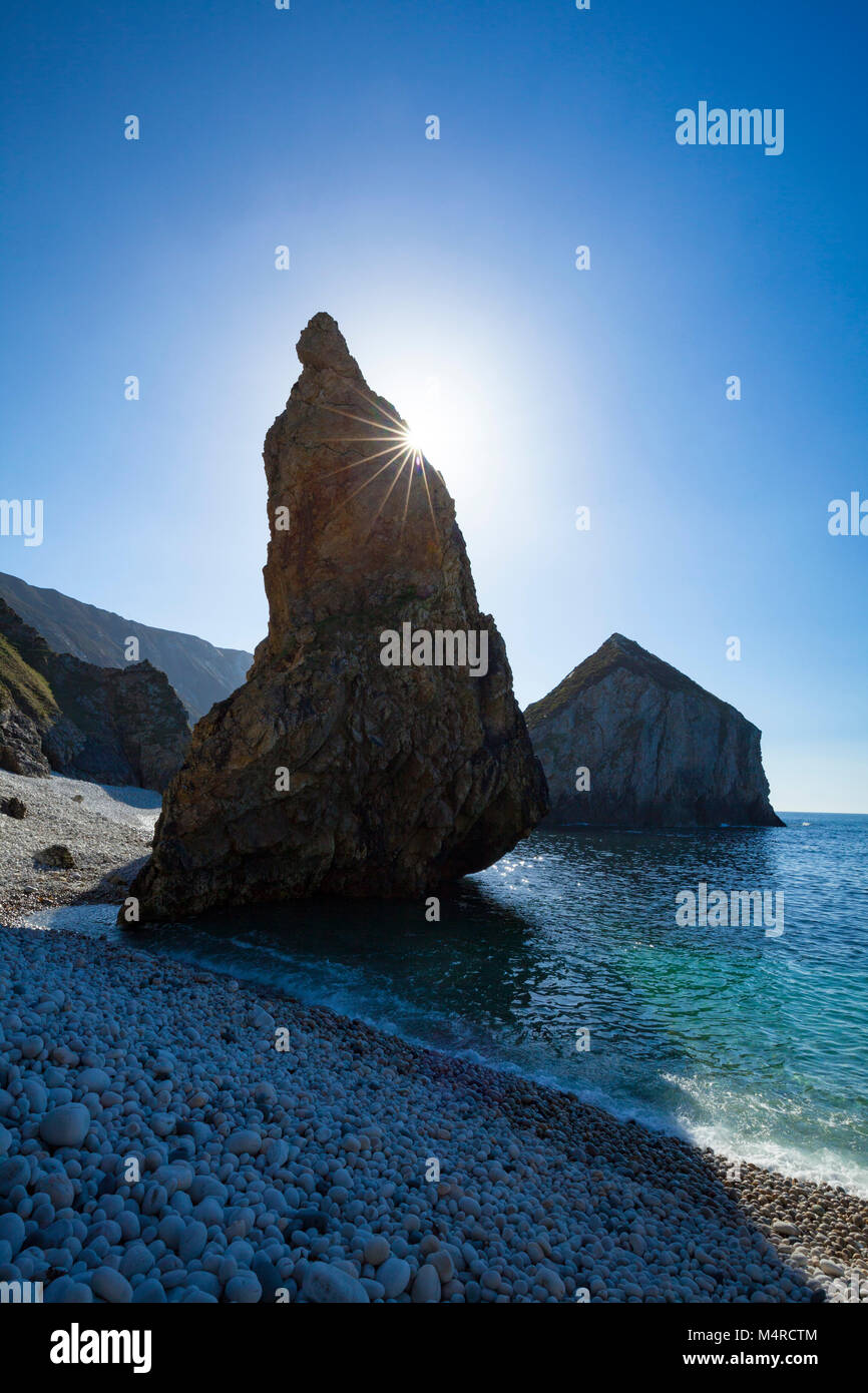 Coastal sea stacks and pinnacles from a storm beach beneath Slieve Tooey, County Donegal, Ireland. Stock Photo