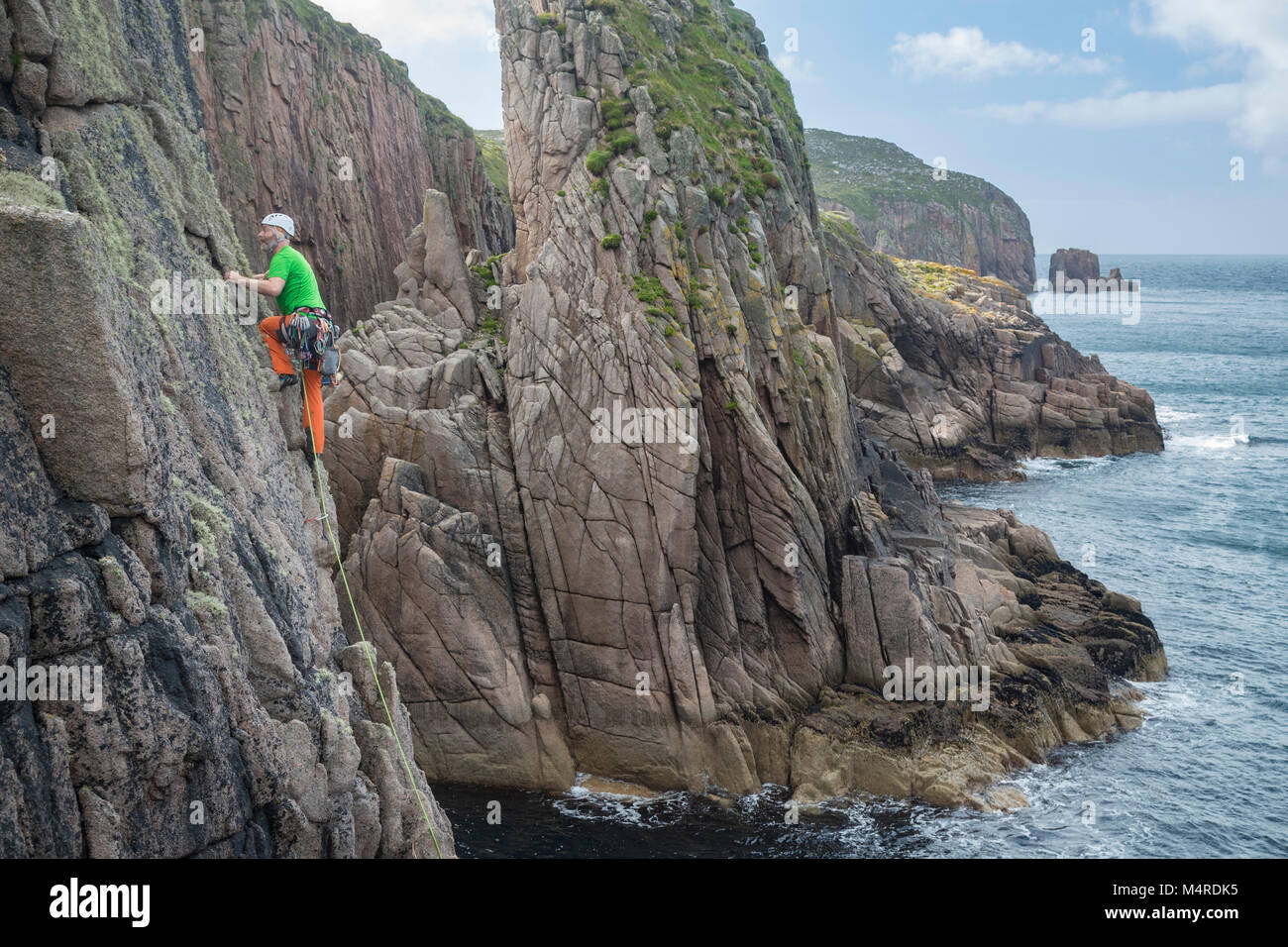Rock climber on the eastern shore of Owey Island, County Donegal, Ireland. Stock Photo