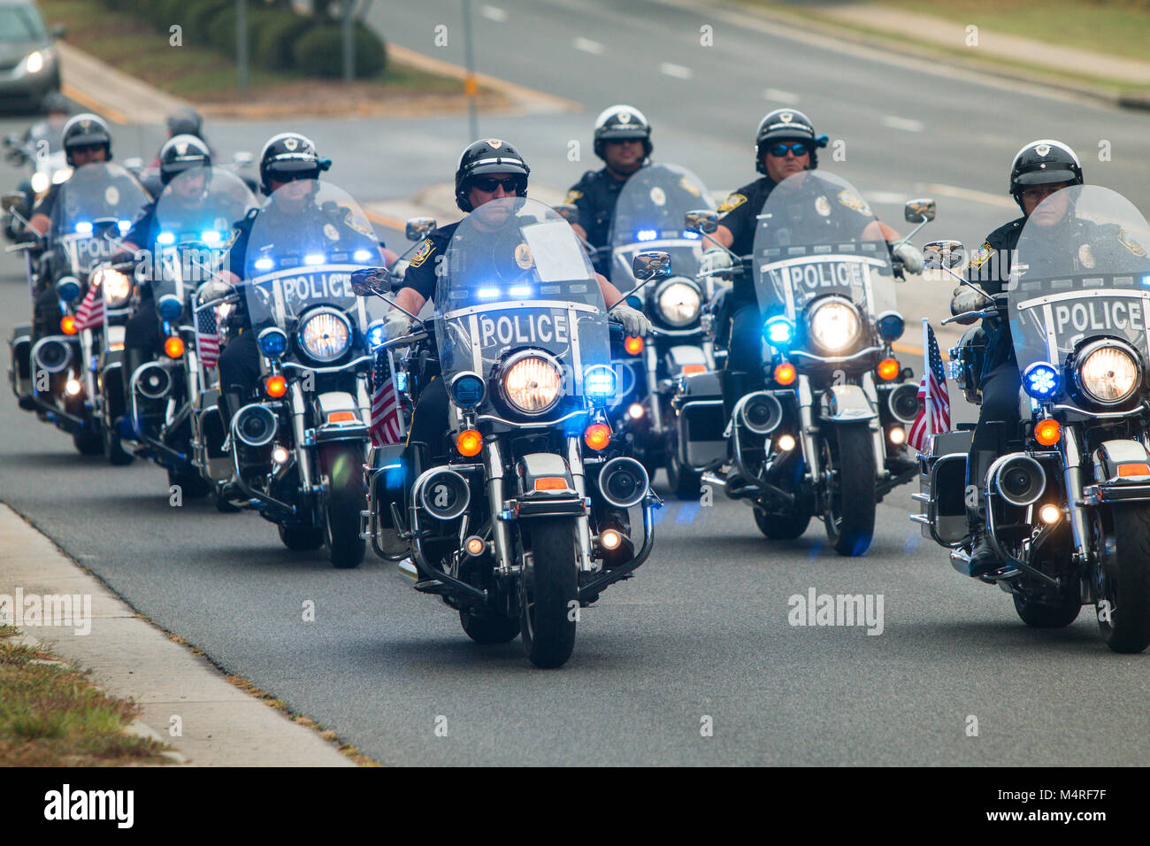 Several police officers on motorcycles provide an escort to motorcyclists about to start a charity bike ride in Buford, GA on October 7, 2017. Stock Photo