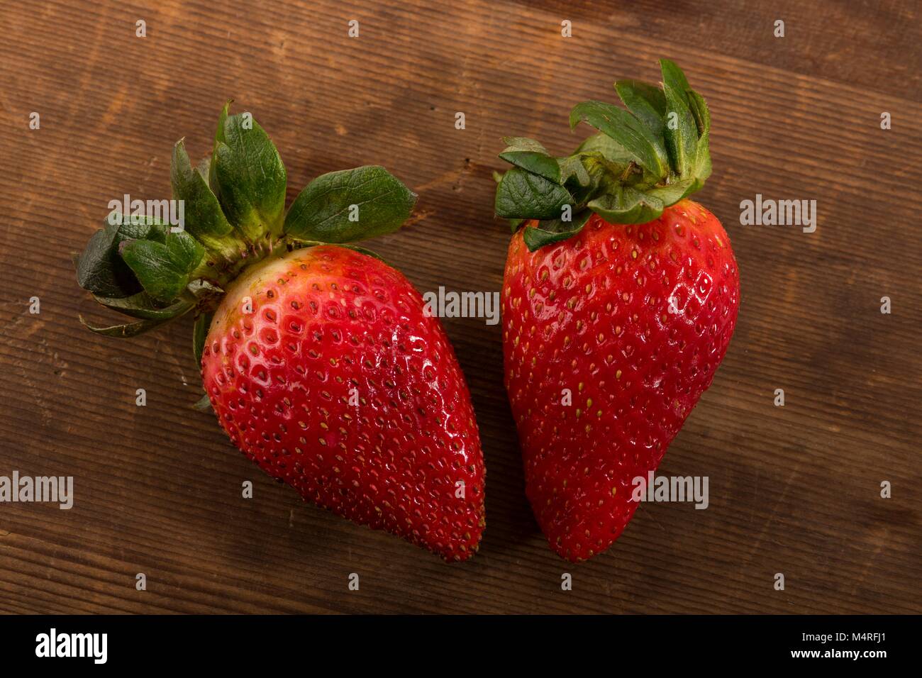 Fresh Red Strawberries Shot From Directly Above in Studio on Brown Wooden Background Stock Photo