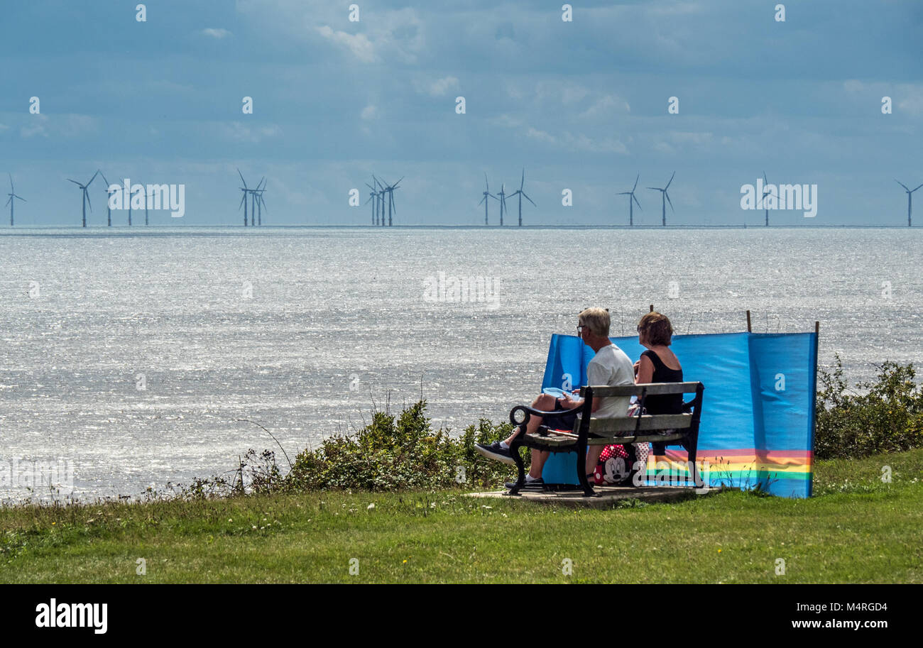 Couple picnic with a view of windfarms off Clacton on Sea Stock Photo