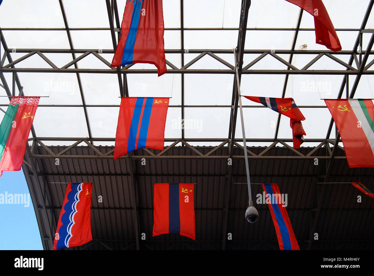 Old USSR Soviet Russian flags are hanging from the ceiling at the Soviet eatery 'Factory canteen SSSR (Заводская Столовая СССР) in Sudak, Ukraine. Stock Photo